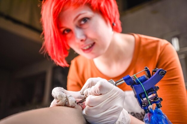 Tattoo master working on professional tattoo machine device in a workshop studio