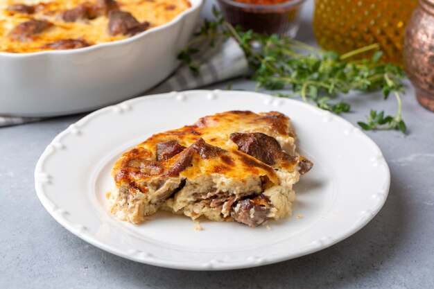 Tave kosi is a national Albanian dish of baked lamb and rice with yoghurt close-up in a pan on the table. horizontal top view from above. Turkish name; Elbasan tava