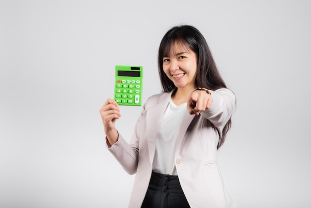 Tax day concept Woman confident smiling holding calculator and finger point to camera