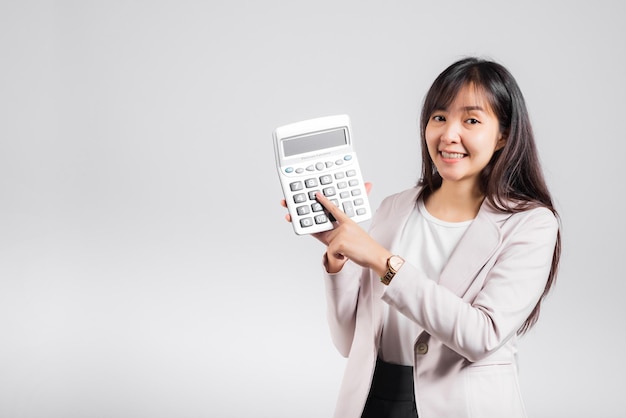 Tax day concept Woman confident smiling holding calculator and finger point device