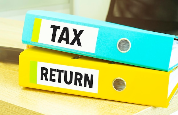 Tax return on colourful folders on table