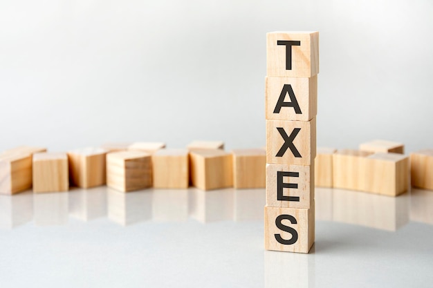 Taxes concept wooden blocks with text on grey table copy space