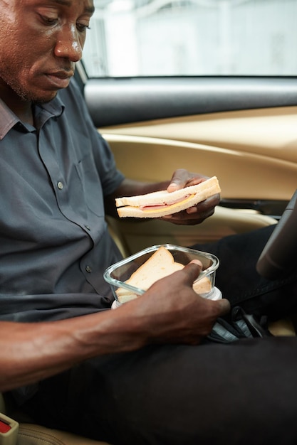 Taxi Driver Eating Sandwich