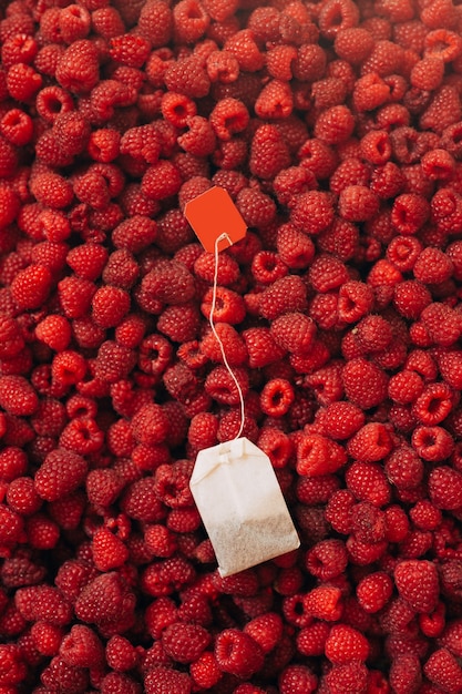 Tea bag on a raspberry background