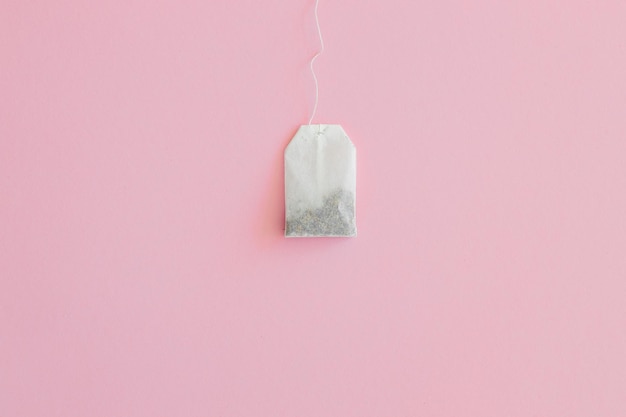 Tea bag with label on pink background space for text