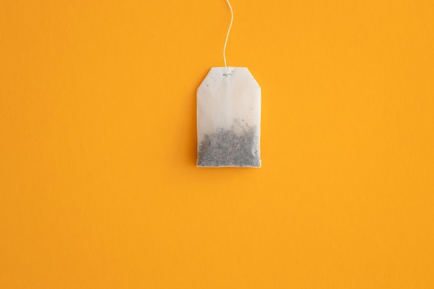 Tea bag with label on yellow background space for text