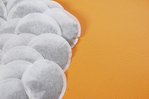 Tea bags and yellow color mug on table