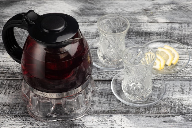 Tea black tea in a teapot on a wooden white background