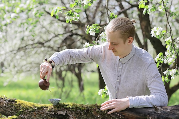 tea ceremony, Asian tea master prepares fresh spring green tea in the garden