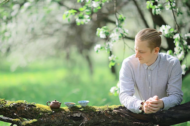 tea ceremony, Asian tea master prepares fresh spring green tea in the garden