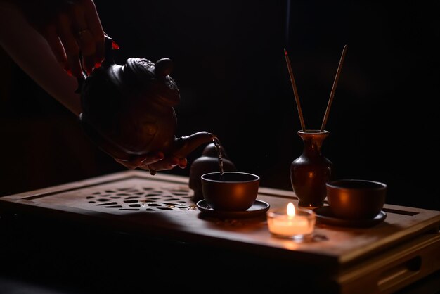 Tea ceremony with candles in the evening