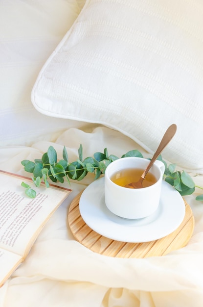 Tea cup next to book and leaves Relax moment