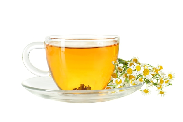 Tea cup and chamomile flowers isolated on white