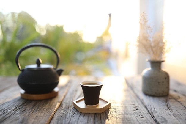 Tea cup and metal black tea pot