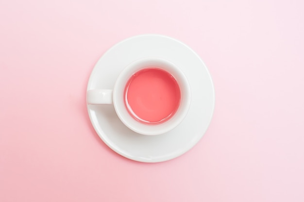 Tea cup on pastel pink background