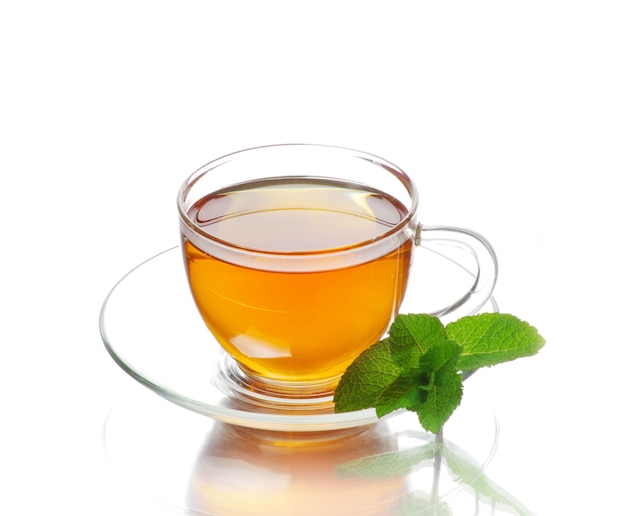 tea in cup with leaf mint and lemon isolated on white background