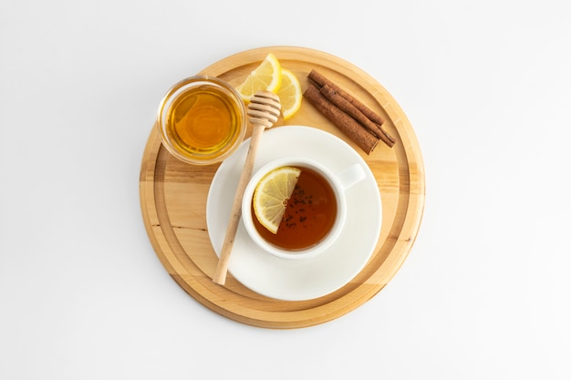 Tea cup with lemon and honey on a white . Hot tea cup isolated, top view flat lay. Flat lay. Autumn, fall or winter drink. copyspace.