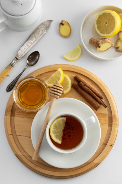 Tea cup with lemon and honey on a white . Hot tea cup isolated, top view flat lay. Flat lay. Autumn, fall or winter drink. copyspace.