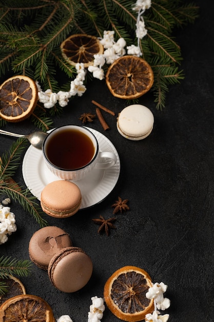 Tea cup with macarons in Christmas decorations