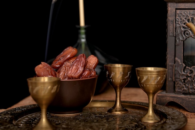 Tea and dried dates on a old wooden table