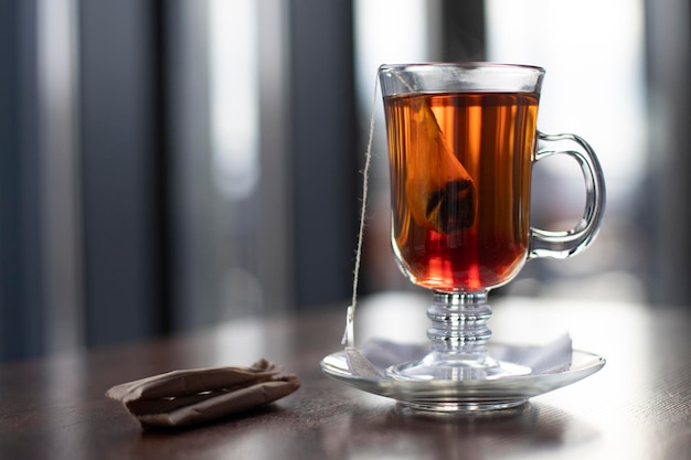 Tea in a glass and bags with sugar on a blurred background Place for an inscription