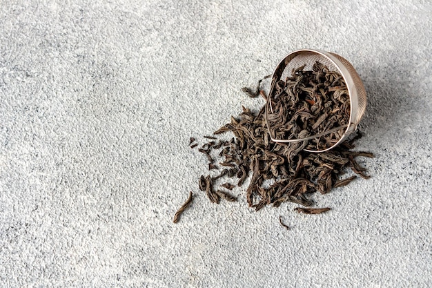 Tea leaves spilled out of a tea strainer a place to copy