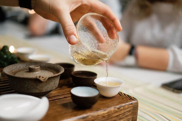 Tea master pouring tea during chinese tea ceremony closeup