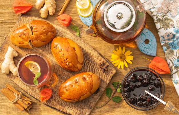 tea party concept with sweet pies on a wooden table top view