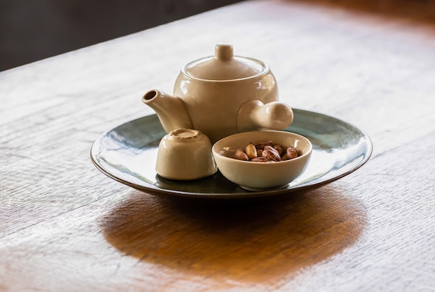 Tea pot and a dish of nut