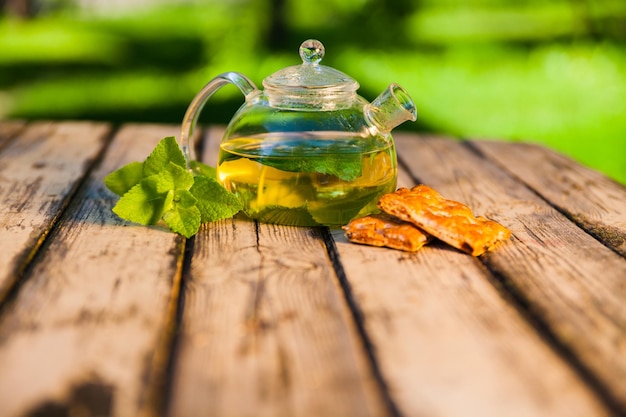 Tea pot of herbal tea on a wooden table