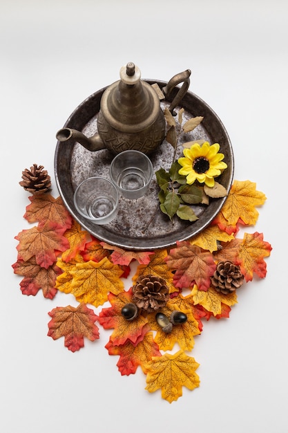 tea set on rustic tray with maple leaves and autumn elements