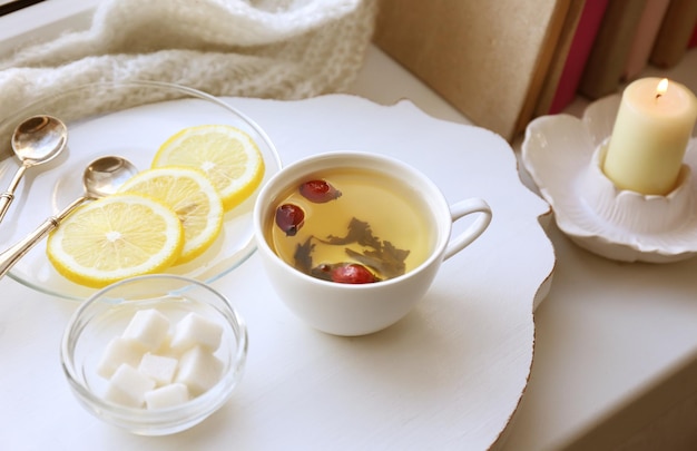 Tea set on a white wooden tray on the windowsill