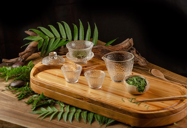 The tea table with instruments teapots cups pancake and tea Shen Puer