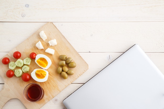 Tea and Turkish, Mediterranean Breakfast  and a closed laptop 