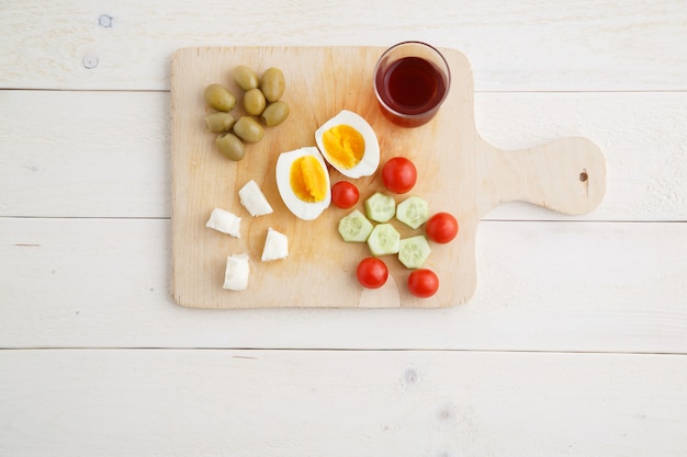 Tea and Turkish, Mediterranean Breakfast on a light wooden tray on a white natural table . 