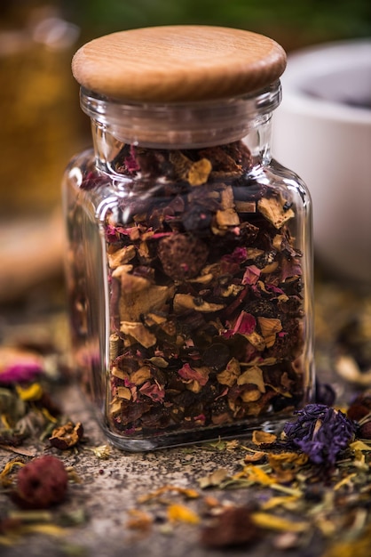 Tea with dried flowers and fruits in jar