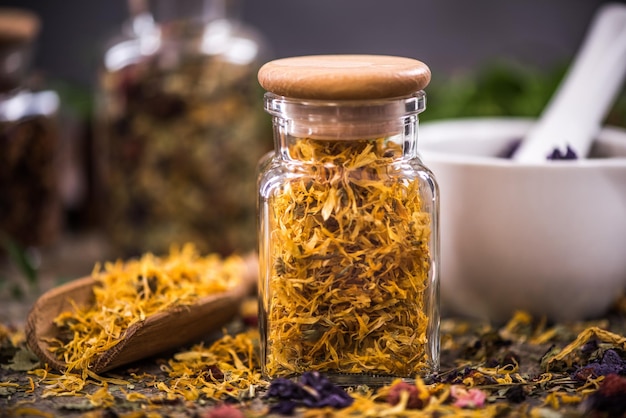 Tea with dried flowers and fruits in jar