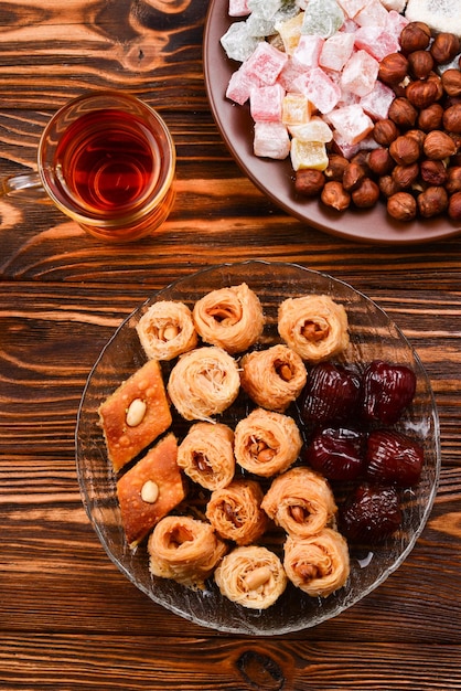 Tea with rahat and dried fruits nuts on a wooden table