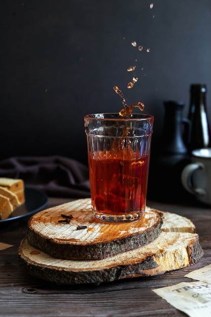 Tea with strawberries and cherries, hot or cold drink with berries. Low key photography.