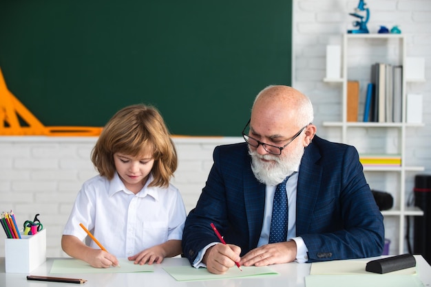 Teacher and child learning together in school education children adaptation