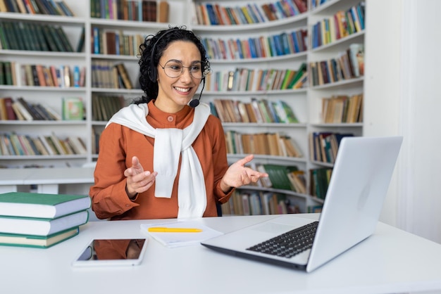 Teacher conducts lessons online woman with video call headset smiling and explaining lecture online