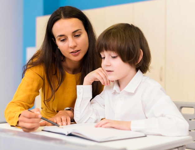 Teacher explaining the lesson to her student