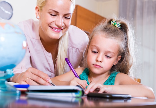 teacher and girl studying at home