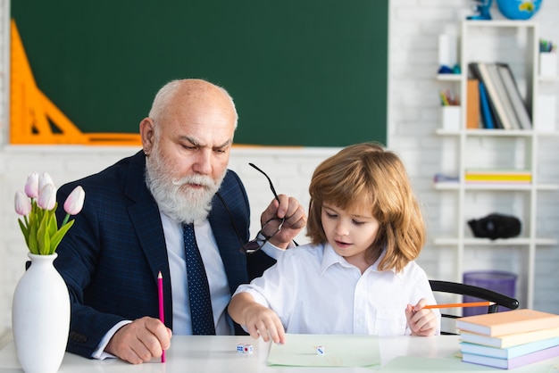 Teacher help to learning Pupil in classroom Education concept School learning concept Boy elementary school