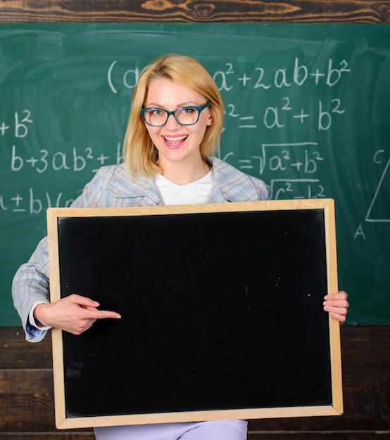 Teacher hold blackboard blank advertisement copy space Information for incoming students Teacher show school advertisement Place for school advertisement School schedule advertisement