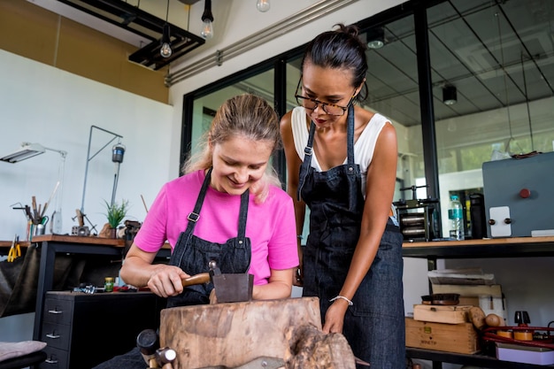 Teacher jeweler and student make jewelry in workshop