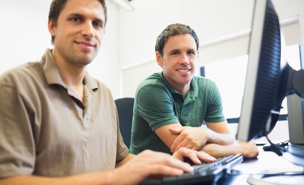 Teacher and mature student in computer room