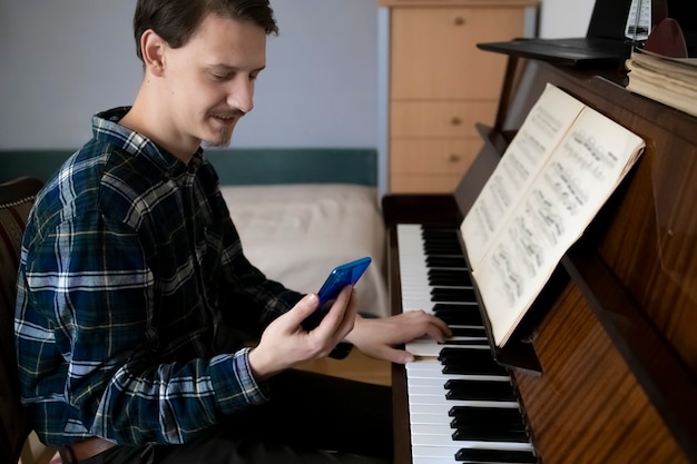 Teacher playing piano during his online lesson