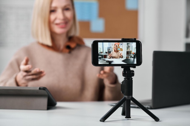 Teacher recording lesson on her smartphone