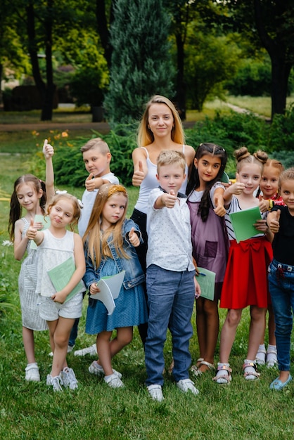 A teacher teaches a class of children in an outdoor Park